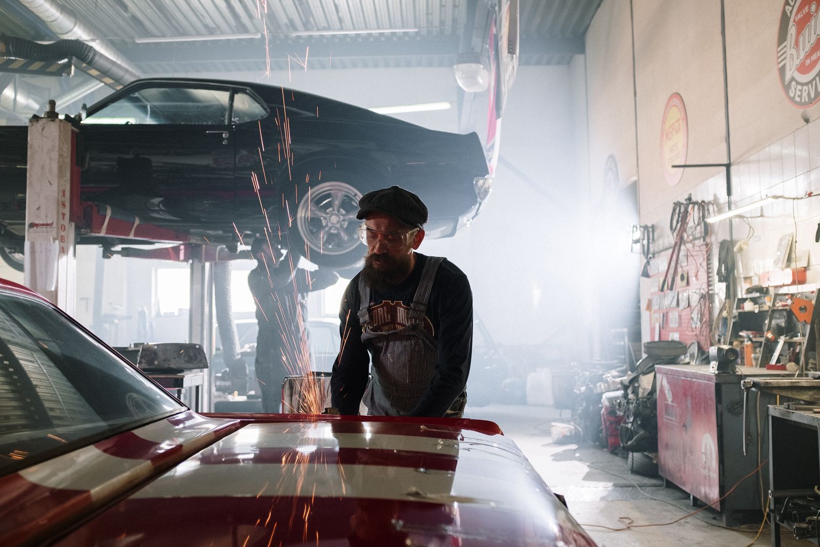 Mechanic servicing a truck on a lift in the repair bay