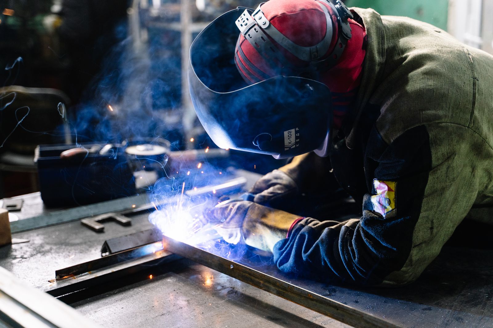 Technician welding a trailer frame repair